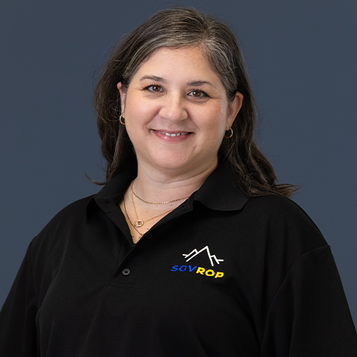 Kristine wearing a black polo shirt with an sgvrop logo